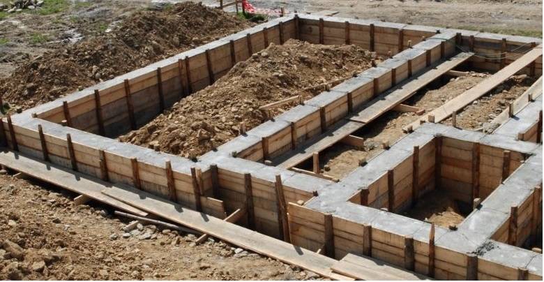 قالبهای چوبی برای فونداسیون بتنی با خاک در داخل آنها در یک سایت ساختمانی