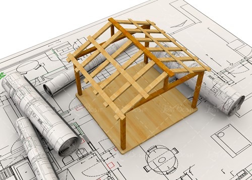 ماکت اسکلت چوبی یک کلبه روی نقشههای معماری